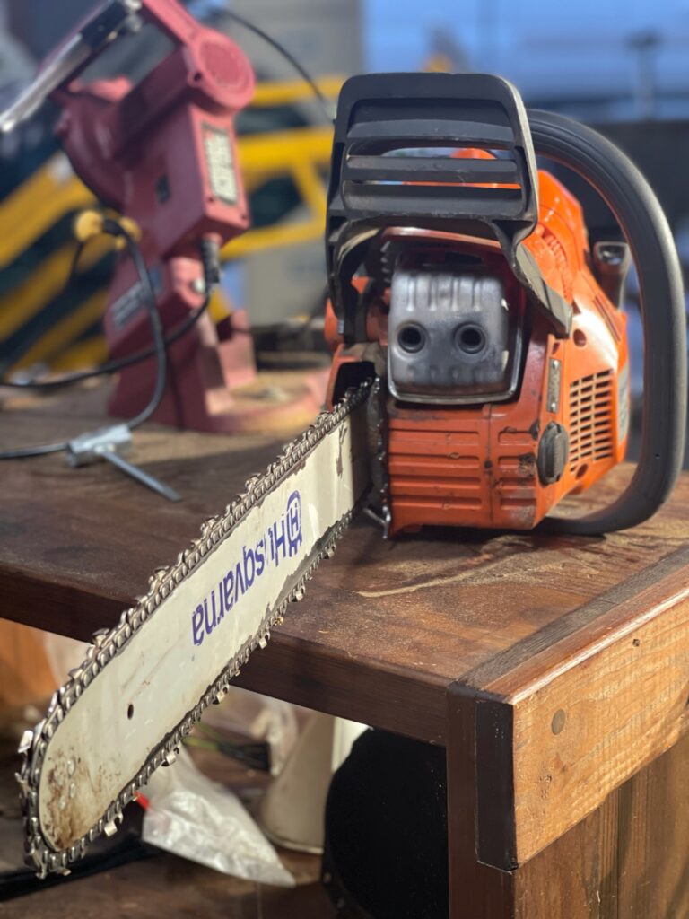 Husqvarna 450 Rancher 20" Chainsaw sitting on chain sharpening bench up close